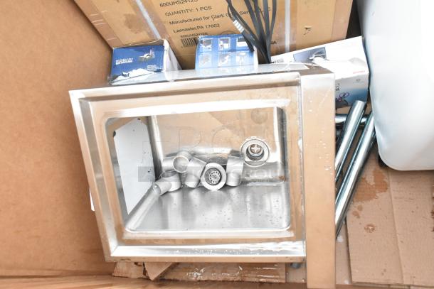 Industrial steel sink with fittings, brand new scratch and dent condition. Box labels show Lancaster, PA manufacturer.