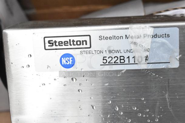 Steelton Metal Products single bowl under mount sink, model 522B11, NSF certified, with visible water droplets.
