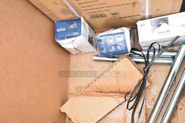 Five brand new scratch and dent auction items including boxes with slight damage, tape dispensers, and metal poles.
