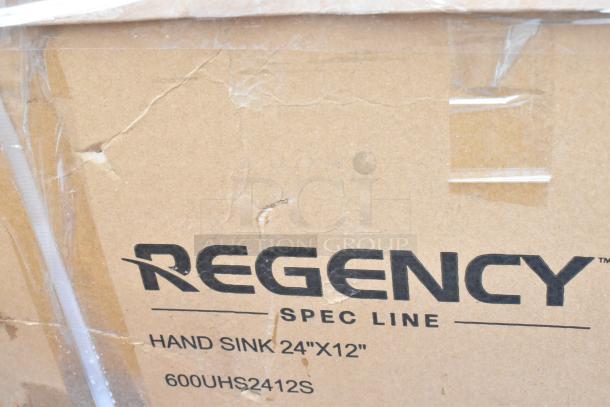 Regency Spec Line hand sink box with visible brand and model 600UHS2412S. Box shows minor wear with scratches and dents.