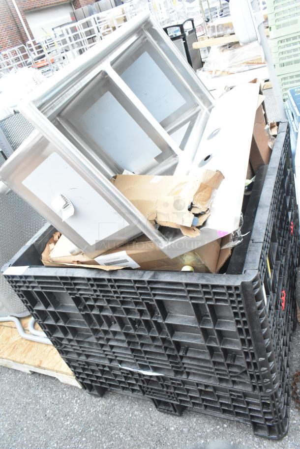 Stacked sinks and items in a crate, all brand new with some scratch and dent markings. Includes mop sink and dolly.