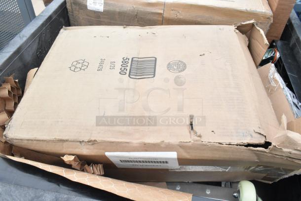 Cardboard box labeled "58050" with visible dents and a recycling symbol, containing assorted new scratch and dent items, including a sink and dolly.