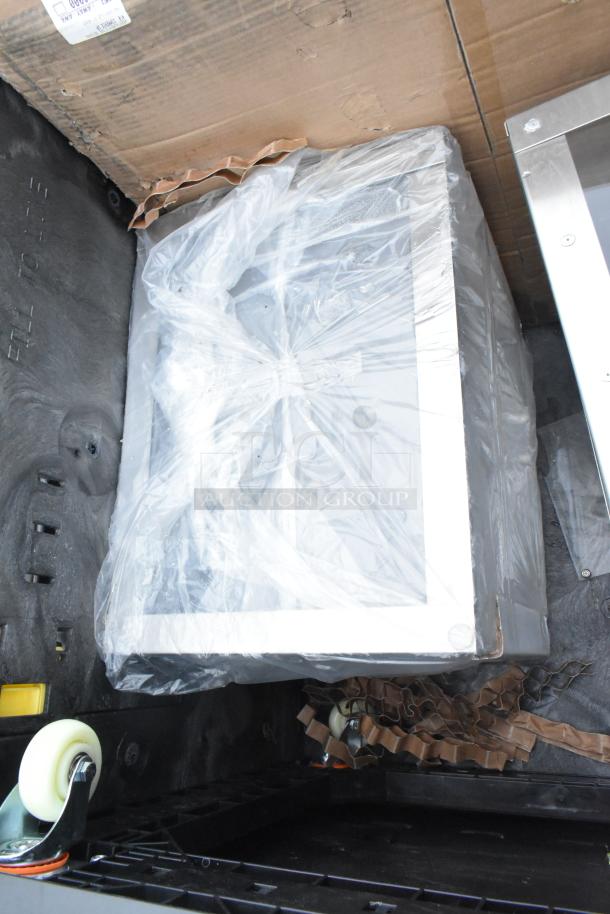 Brand new scratch and dent items, including a sink, mop sink, and dolly. Items appear packaged and in good condition.