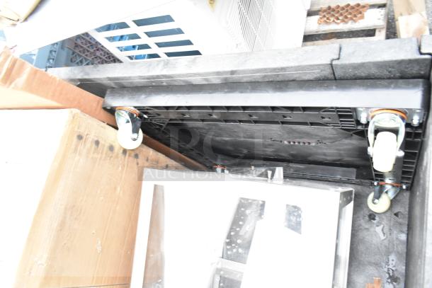 8 new scratch and dent items including a stainless steel sink, mop sink, and dolly with casters.