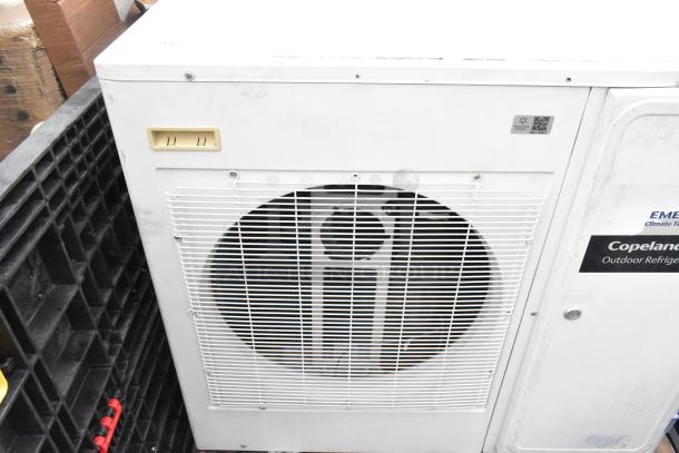 Emerson XFAM-037Z-TFC-081 metal split air conditioner, 208-230V, 3 phase, white, Copeland outdoor refrigeration label visible.