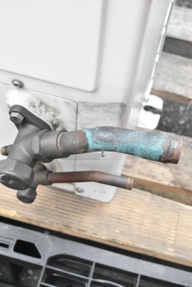 Emerson XFAM-037Z-TFC-081 metal split type AC, 208-230V, 3-phase. Visible pipes show corrosion, suggesting wear.