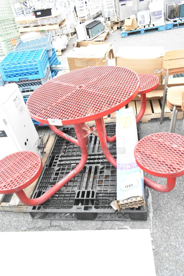 Red metal round table set with attached seats, includes LED light pack. Good condition, lot tag visible.