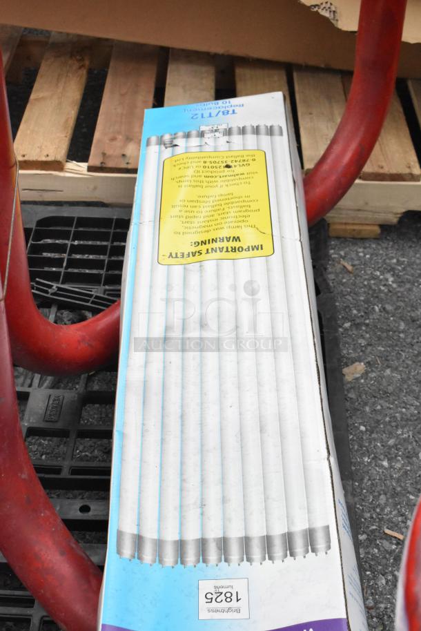 Red metal table with attached round seats, featuring an LED light pack. T8/12 fluorescent tubes visible in the background.