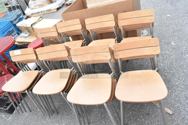 Set of wooden dining chairs with chrome frames, excellent condition, stackable. Auction offers 30 chairs per bid.