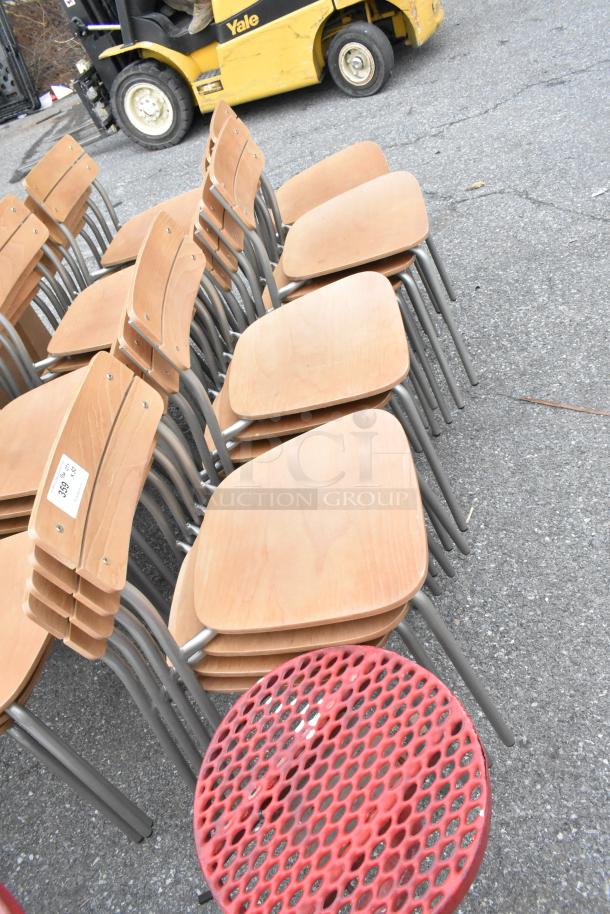 Stack of wood-pattern dining height chairs with chrome finish frames. Includes 30 chairs. Visible label indicates auction item number.
