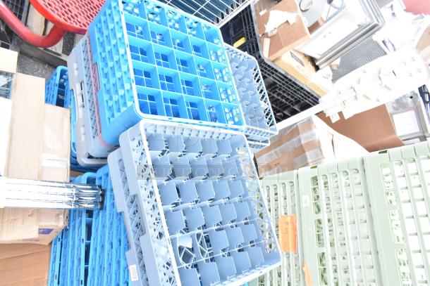 Blue and gray dish caddies stacked among various items and boxes, good condition, ideal for organizing or transport.