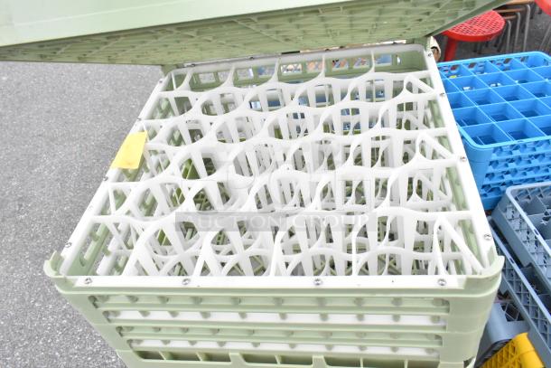 Lot of various dish caddies, including a light green caddie with a grid-like insert. Caddies stack neatly, suitable for storage.