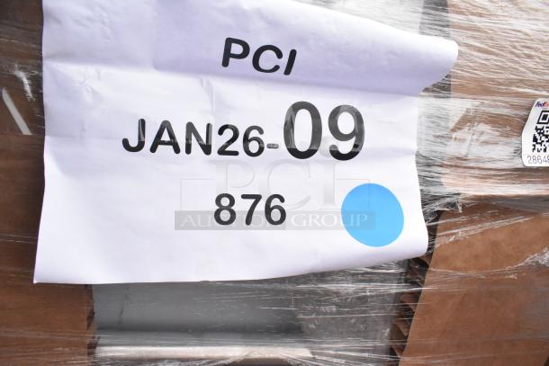 Plastic-wrapped package labeled "PCI JAN26-09, 876" with QR code and blue dot, indicating auction lot of scratch and dent items, including sinks.