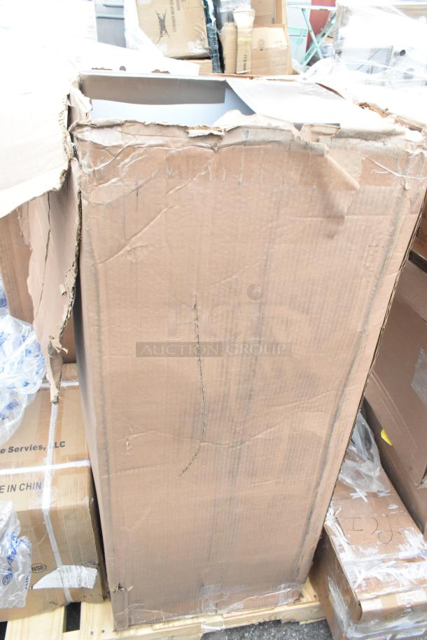 Cardboard box containing scratch and dent items, including a sink and dunnage rack. Box shows visible damage.