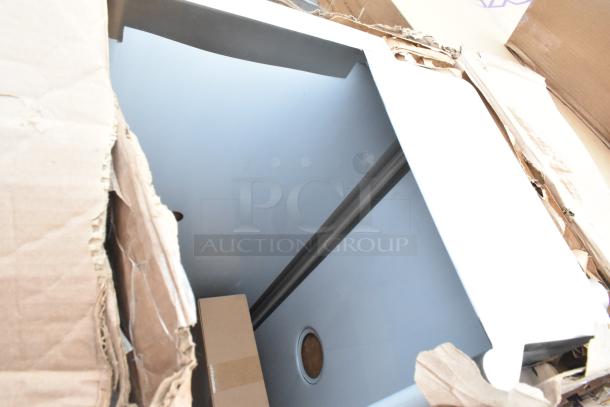 Brand new scratch and dent sink with visible packaging damage, includes dunnage rack and additional items.