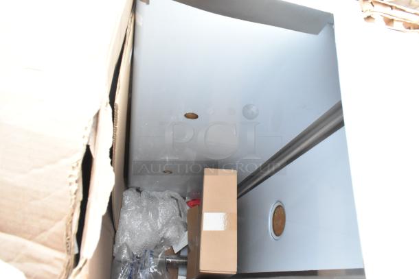 Brand new scratch and dent items including a sink and dunnage rack in packaging. Visible bubble wrap and cardboard for protection.