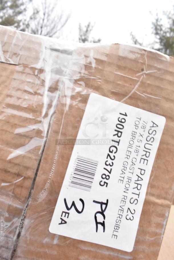 Box labeled "Assure Parts 23," containing 3 pieces of cast iron top broiler grates, code 190RTG23785, new condition.