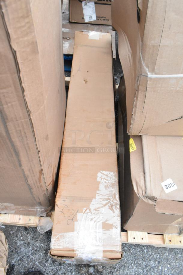 Cardboard box containing 8 new scratch and dent items, including boiler grate and door gasket. Box shows slight wear.