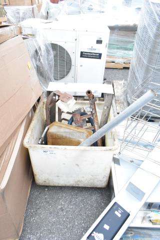 White poly bin containing various metal parts and tools, slightly soiled, label 367 visible on side.