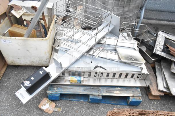 Pallet lot with various stainless steel items and a metal rack in used condition on a blue pallet.