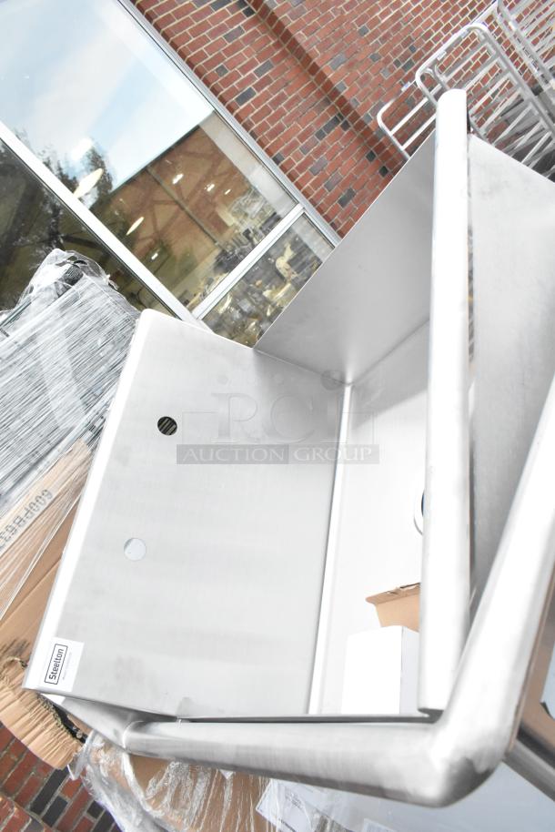 Stainless steel sink with visible light scratches. Includes manufacturer label "Steelton". Part of a scratch and dent lot.