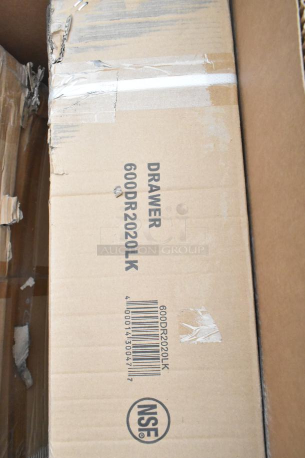 Cardboard box labeled "DRAWER 600DR2020LK," shows minor packaging damage, NSF mark visible. Part of scratch and dent lot.