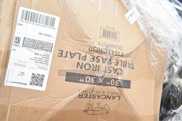 Cardboard box labeled "Lancaster Table & Seating" with visible damage, packed with new scratch and dent items. Shipping labels visible.