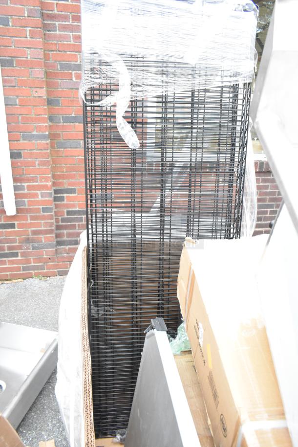 Packaged wire shelves next to cardboard boxes, part of a lot with a sink and drawer. New condition with minor scratches.