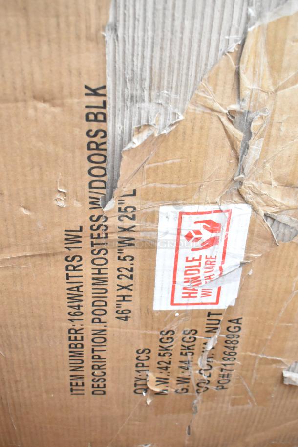 Damaged shipping box with visible text: "Item Number: 164WAITRS W/DOORS BLK." Contains podium host station, 46" H x 22.5" W x 25" L, marked "Handle With Care."
