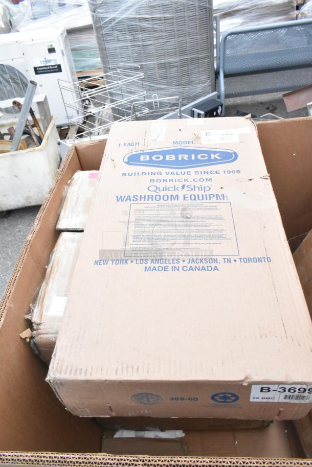 Box containing Bobrick washroom equipment, labeled "QuickShip," brand new with minor damage, made in Canada.