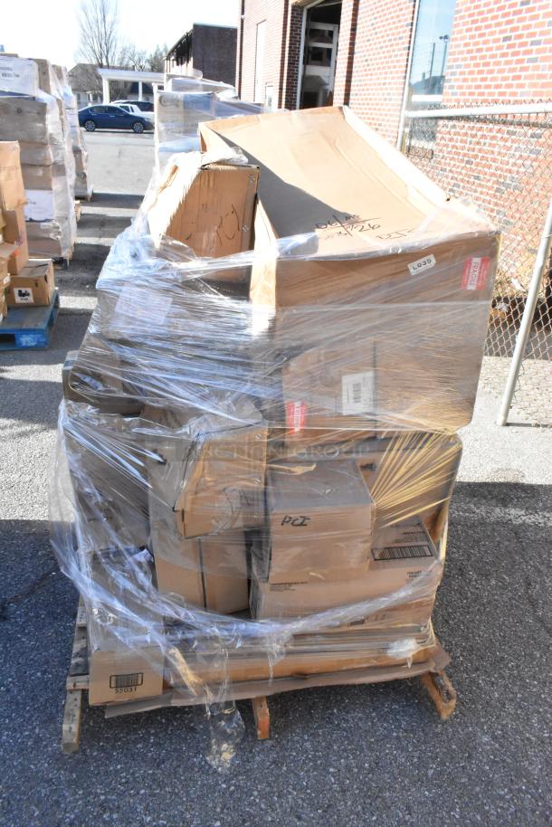Plastic-wrapped pallet with various sealed cardboard boxes, labeled as containing scratch and dent items for auction.