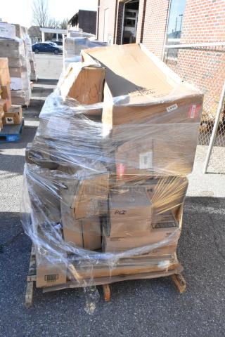 Plastic-wrapped pallet with various sealed cardboard boxes, labeled as containing scratch and dent items for auction.