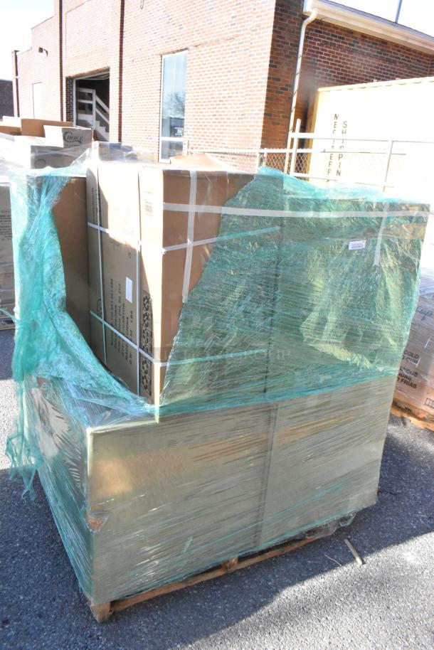 Pallet with 8 brand new scratch and dent items, including Martha Stewart Taytum faux leather office chair in boxes, wrapped in green plastic.