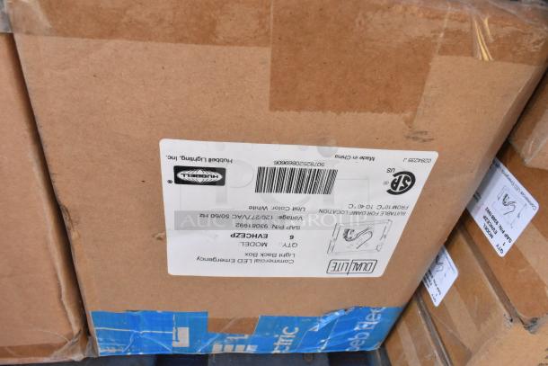 Cardboard boxes labeled Hubbell Lighting, model DUAL-LITE ENHCPZ, containing LED emergency lights; new condition.