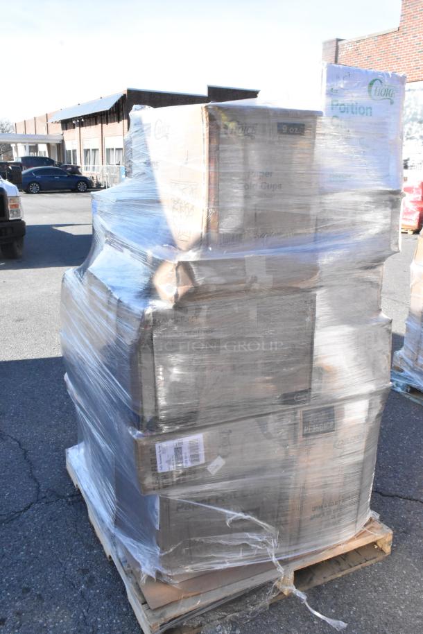 Shrink-wrapped pallet with boxes of new scratch and dent items, including gloves, hot cups, cold cups, and paper towels.