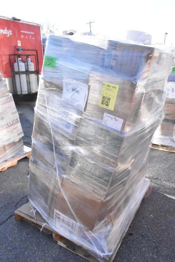 Shrink-wrapped pallet of assorted scratch and dent items, including bags, plates, and containers, with visible shipping labels and codes.