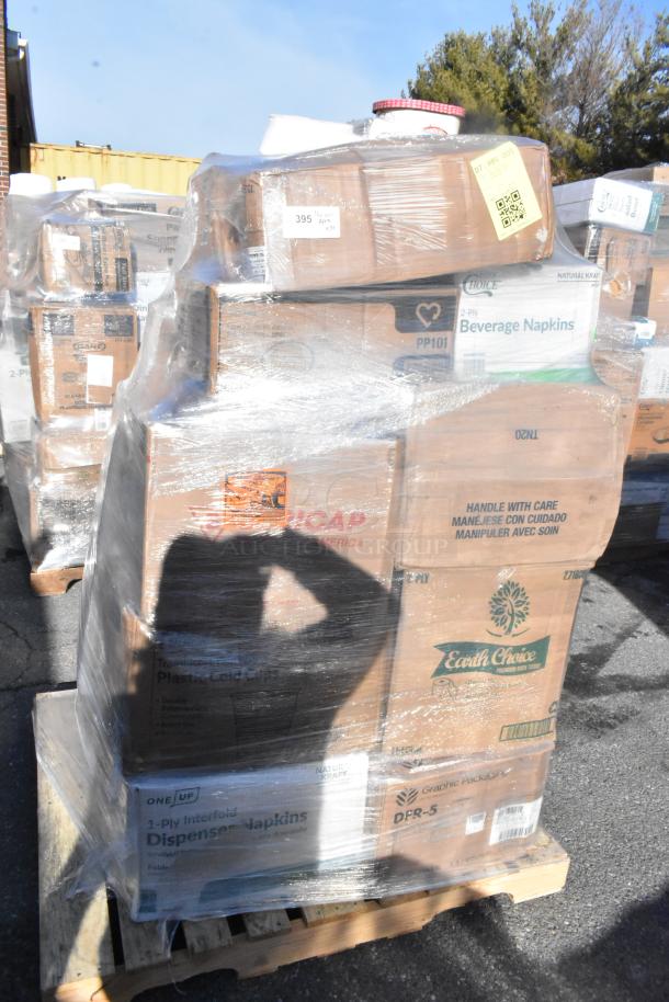Pallet with multiple boxes of scratch and dent items, including containers, trays, and napkins, wrapped in plastic.
