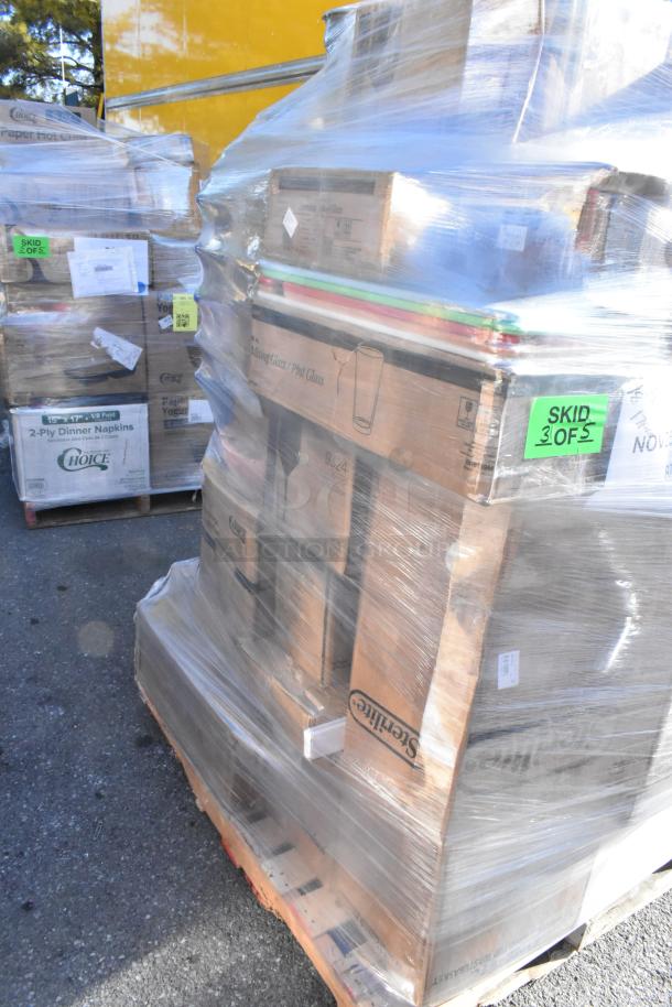 Pallet of various kitchen items, including plates and glasses, wrapped in plastic. Labeled "SKID 3 OF 5."