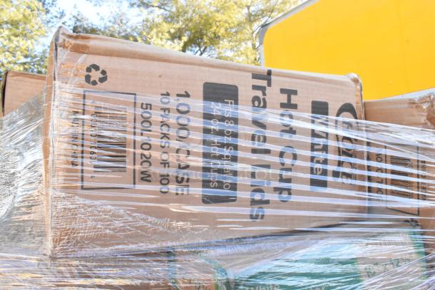 Cardboard box labeled "Hot Cup Travel Lids, 1000 Case," wrapped in plastic. Marked "Made in China." Part of scratch and dent sale lot.