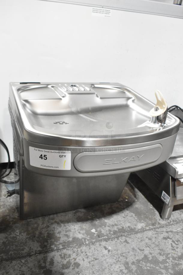 Elkay EZFSB_1H metal wall mount water fountain, 115V, 1 phase. Features include stainless steel finish and integrated nozzle.