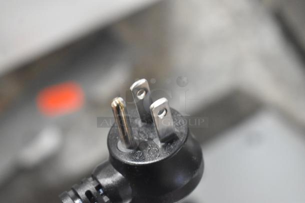 Close-up of a three-prong electrical plug for the Elkay EZFSB_1H water fountain, 115 volts, 1 phase.