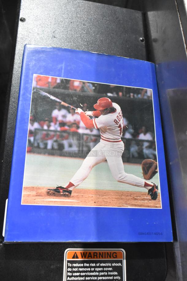 Baseball book with dust jacket featuring a player in action, ISBN 0-8317-4025-6, slight wear on cover.
