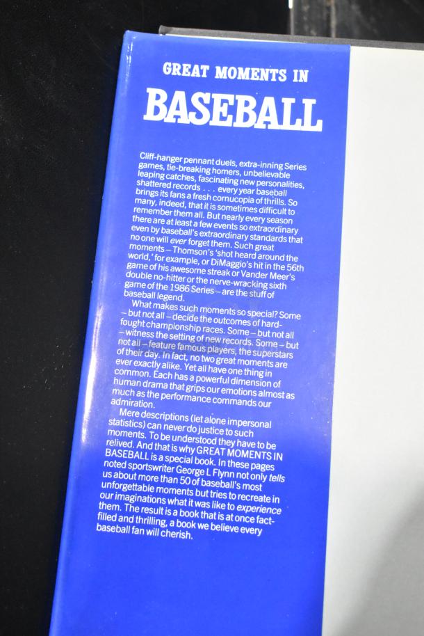 Cover of "Great Moments in Baseball" book, featuring a blue section with descriptive text about memorable baseball events.