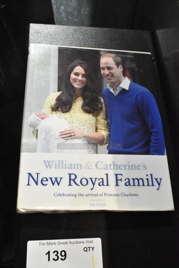 Book titled "William & Catherine's New Royal Family" by Ian Lloyd. Celebrates the arrival of Princess Charlotte. Cover shows a photo of a family. Condition appears good. Lot number 139.