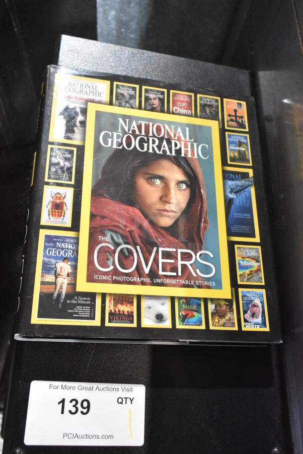 National Geographic book titled "The Covers" with iconic images, new condition, auction lot 139.