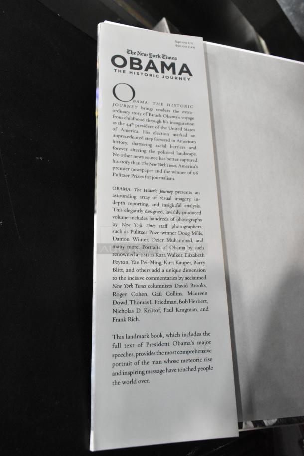 Alt text: "New York Times book 'Obama: The Historic Journey' cover, includes visual imagery, essays, and Obama's speeches."