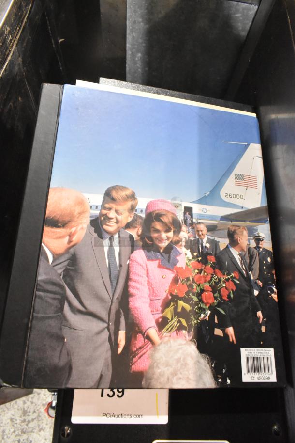 Thirteen assorted books with notable covers, auction tag visible, offering diverse topics.