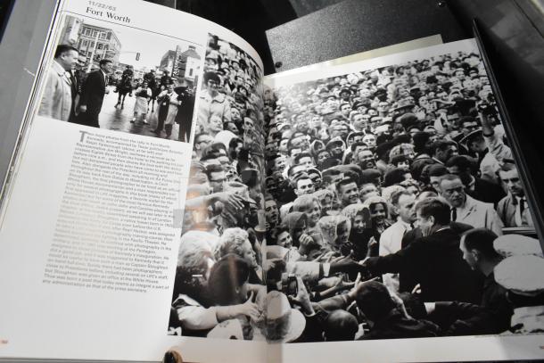 Open book with black and white photos of a historical crowd scene and accompanying text about Fort Worth.