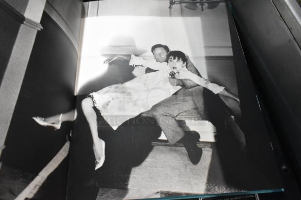 A stack of 13 various books, mixed genres, good condition. Books are fanned out, showing a black and white book cover.