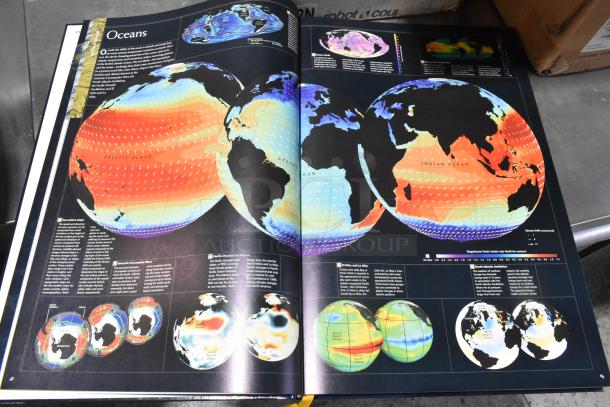 Open world atlas book displaying colorful global ocean maps with detailed oceanographic data and text.